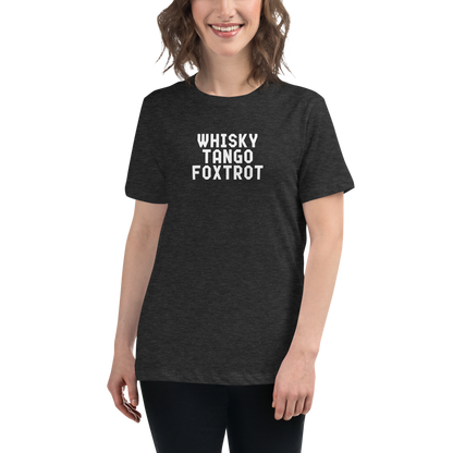 "Whisky Tango Foxtrot (What the f#ck)" printed on a dark grey heather women's relaxed t-shirt worn by a female