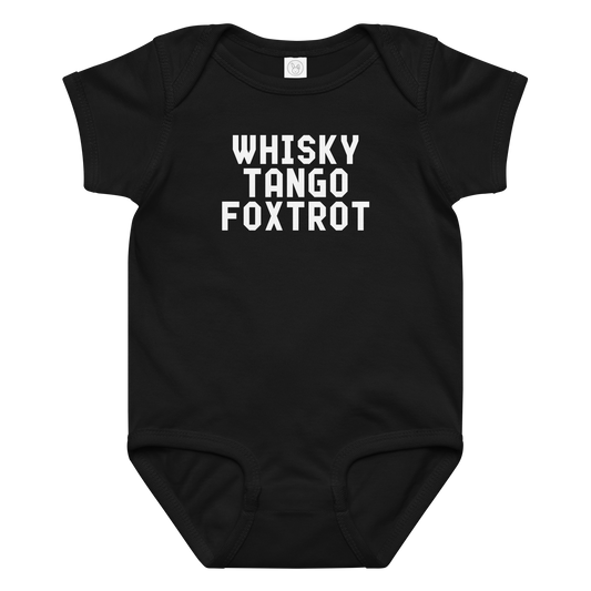 "Whisky Tango Foxtrot (What the f#ck)" printed on a black baby jersey bodysuit laying on a flat surface amongst other clothes