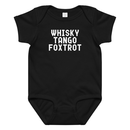 "Whisky Tango Foxtrot (What the f#ck)" printed on a black baby jersey bodysuit laying on a flat surface amongst other clothes