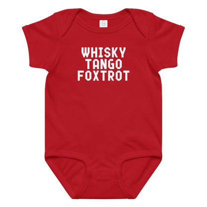 "Whisky Tango Foxtrot (What the f#ck)" printed on a red baby jersey bodysuit laying on a flat surface amongst other clothes