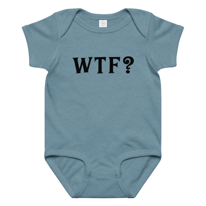 "WTF? (What the f#ck?)" printed on a vintage indigo baby jersey bodysuit laying on a flat surface amongst other clothes