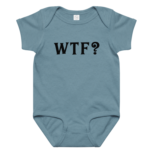 "WTF? (What the f#ck?)" printed on a vintage indigo baby jersey bodysuit laying on a flat surface amongst other clothes