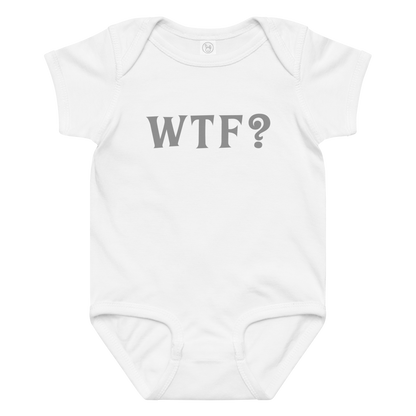 "WTF? (What the f#ck?)" printed on a white baby jersey bodysuit laying on a flat surface amongst other clothes
