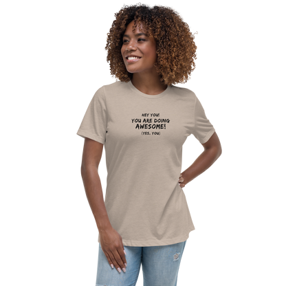 "Hey You! You are doing awesome! (Yes, you)" printed on a heather stone women's relaxed t-shirt worn by a female