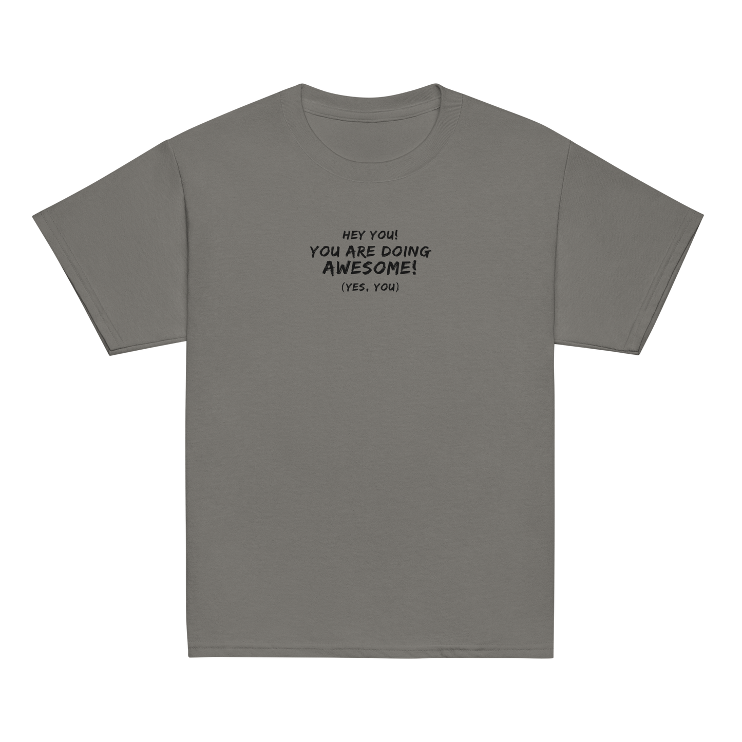 "Hey You! You are doing awesome! (Yes, you)" printed on a charcoal youth classic tee laying on a flat surface