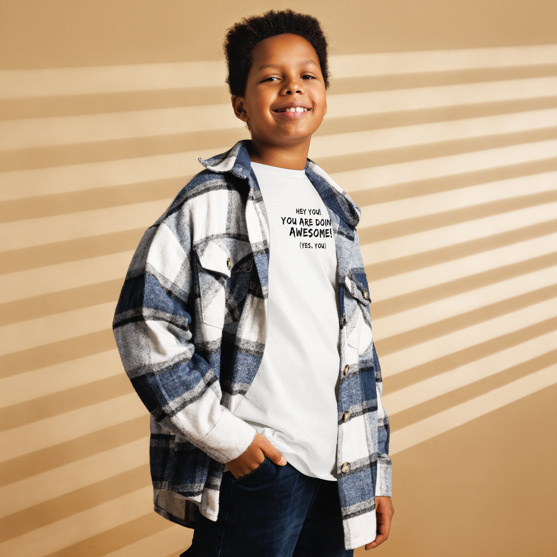 "Hey You! You are doing awesome! (Yes, you)" printed on a white youth classic tee worn by a male also wearing a jacket