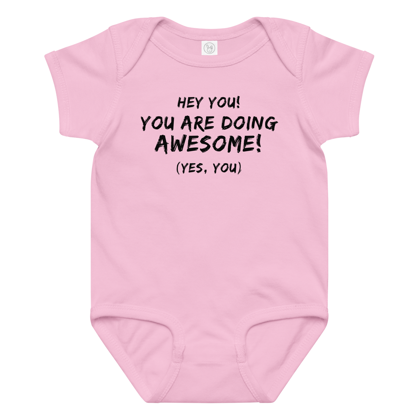 "Hey You! You are doing awesome! (Yes, you)" printed on a pink baby jersey bodysuit laying on a flat surface amongst other clothes