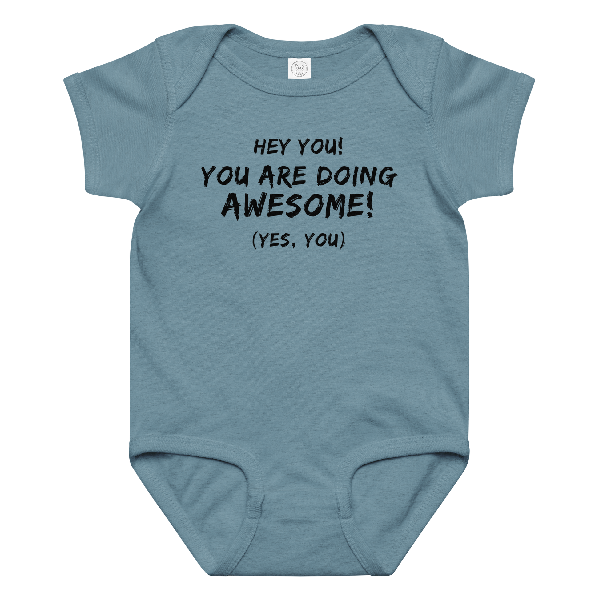 "Hey You! You are doing awesome! (Yes, you)" printed on a vintage indigo baby jersey bodysuit laying on a flat surface amongst other clothes