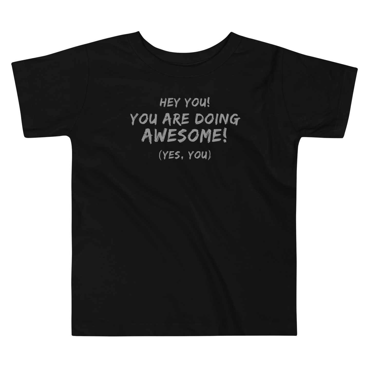 "Hey You! You are doing awesome! (Yes, you)" printed on a black toddler short sleeve tee laying on a flat surface