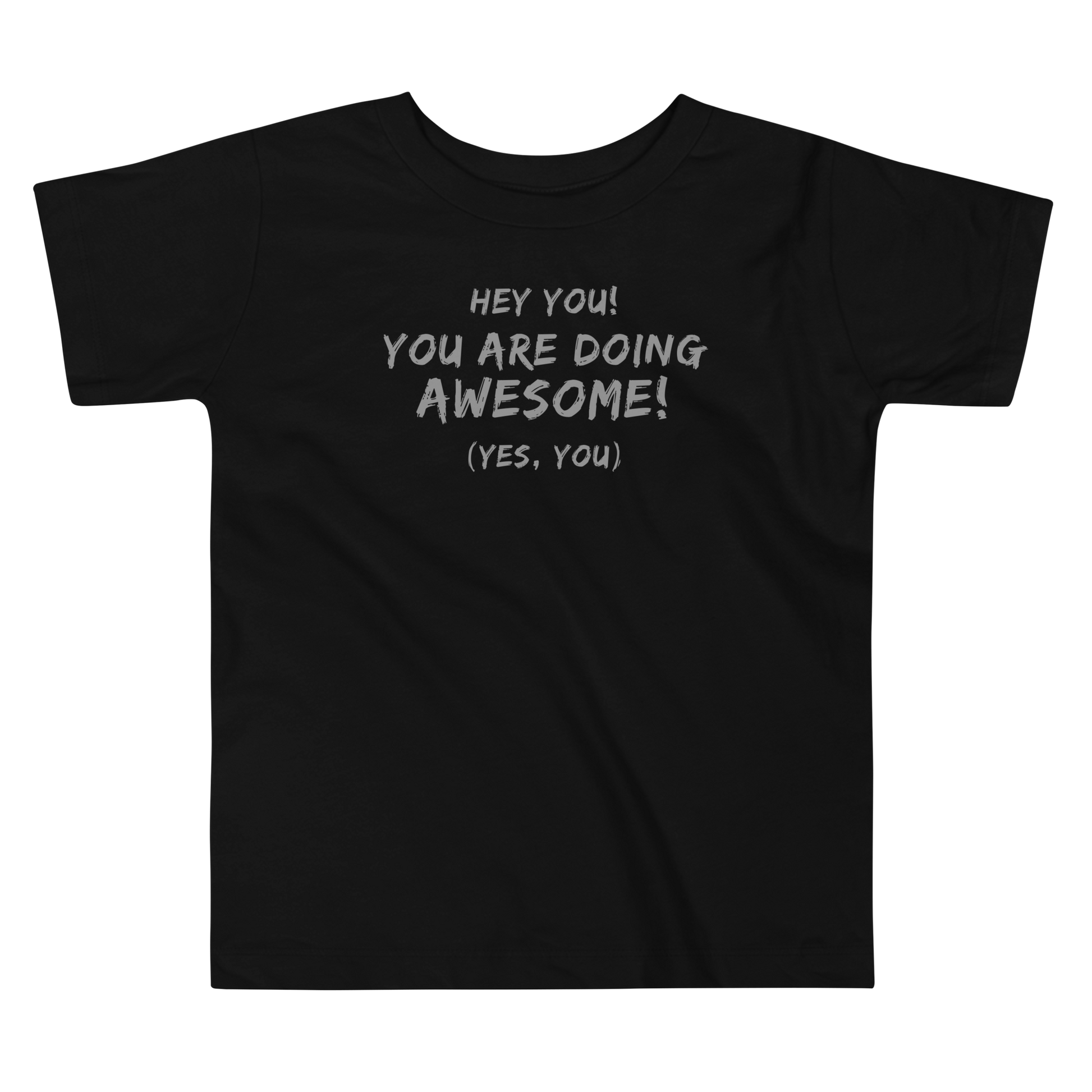 "Hey You! You are doing awesome! (Yes, you)" printed on a black toddler short sleeve tee laying on a flat surface