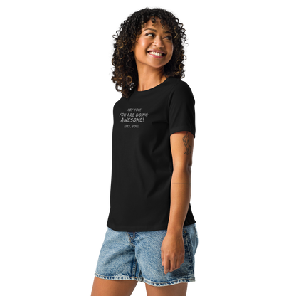 "Hey You! You are doing awesome! (Yes, you)" printed on a black women's relaxed t-shirt worn by a female
