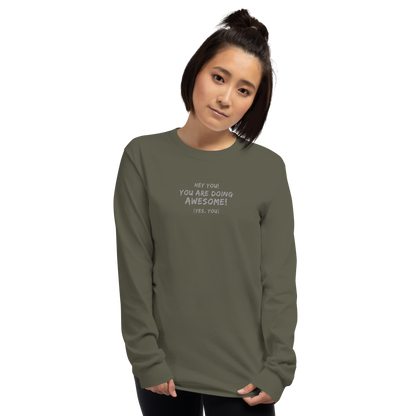 "Hey You! You are doing awesome! (Yes, you)" printed on a military green men's long sleeve shirt worn by a female