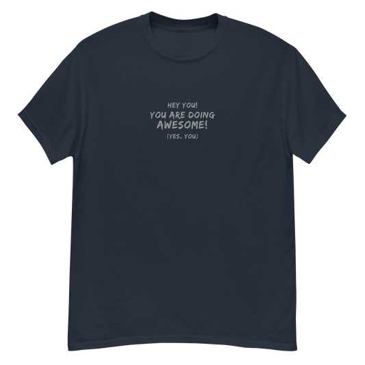 "Hey You! You are doing awesome! (Yes, you)" printed on a navy unisex classic tee laying on a flat surface