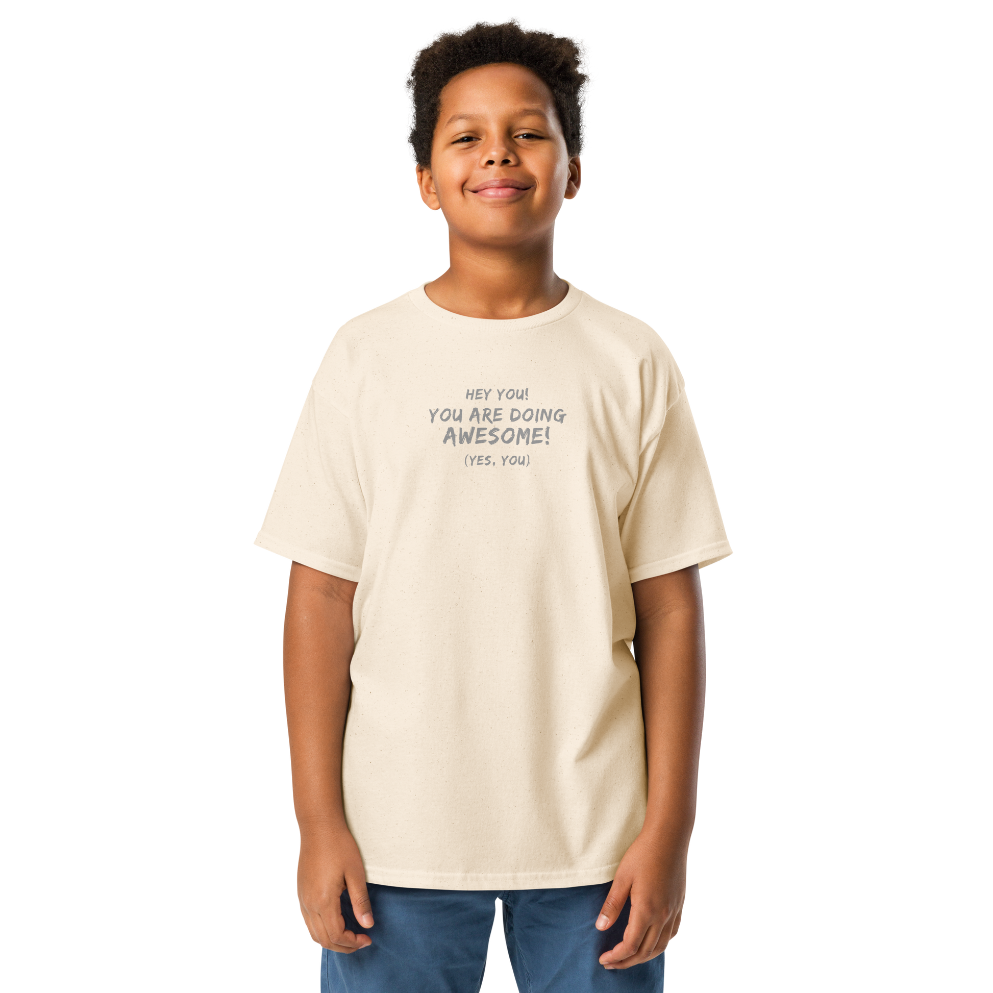 "Hey You! You are doing awesome! (Yes, you)" printed on a natural youth classic tee worn by a male