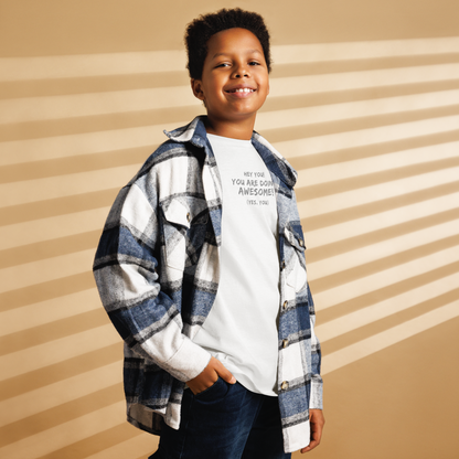 "Hey You! You are doing awesome! (Yes, you)" printed on a white youth classic tee worn by a male also wearing a jacket