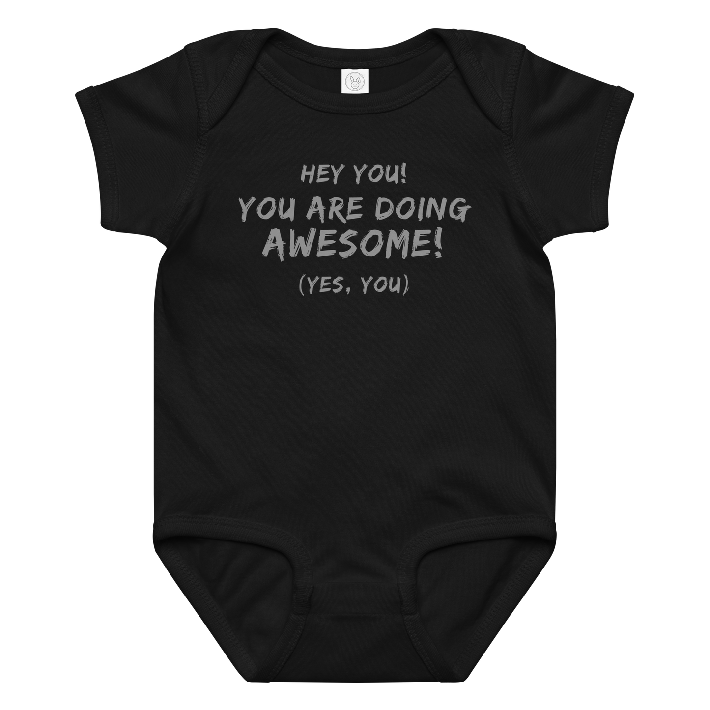 "Hey You! You are doing awesome! (Yes, you)" printed on a black baby jersey bodysuit laying on a flat surface amongst other clothes