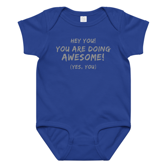 "Hey You! You are doing awesome! (Yes, you)" printed on a royal baby jersey bodysuit laying on a flat surface amongst other clothes