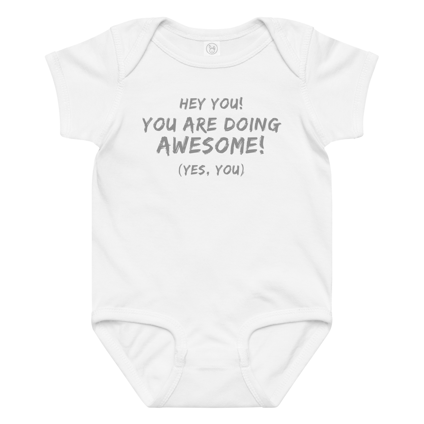 "Hey You! You are doing awesome! (Yes, you)" printed on a white baby jersey bodysuit laying on a flat surface amongst other clothes