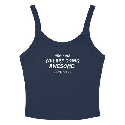 "Hey You! You are doing awesome! (Yes, you)" printed on a solid navy blend women's micro-rib tanktop laying on a flat surface amongst sunglasses and shorts