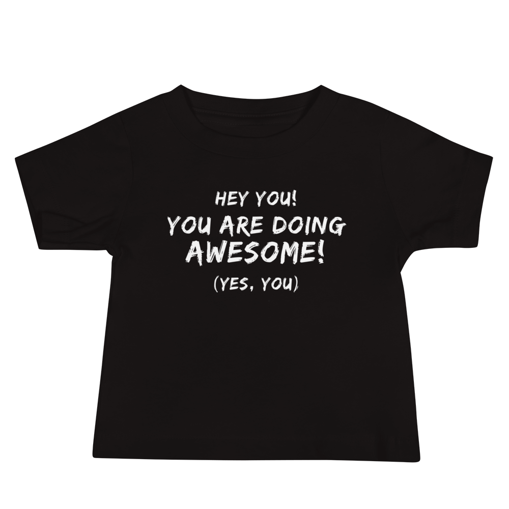 "Hey You! You are doing awesome! (Yes, you)" printed on a black baby jersey short sleeve tee laying on a flat surface