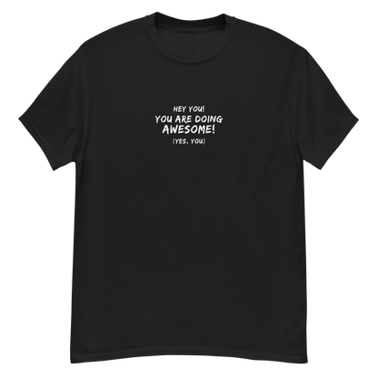 "Hey You! You are doing awesome! (Yes, you)" printed on a black unisex classic tee laying on a flat surface