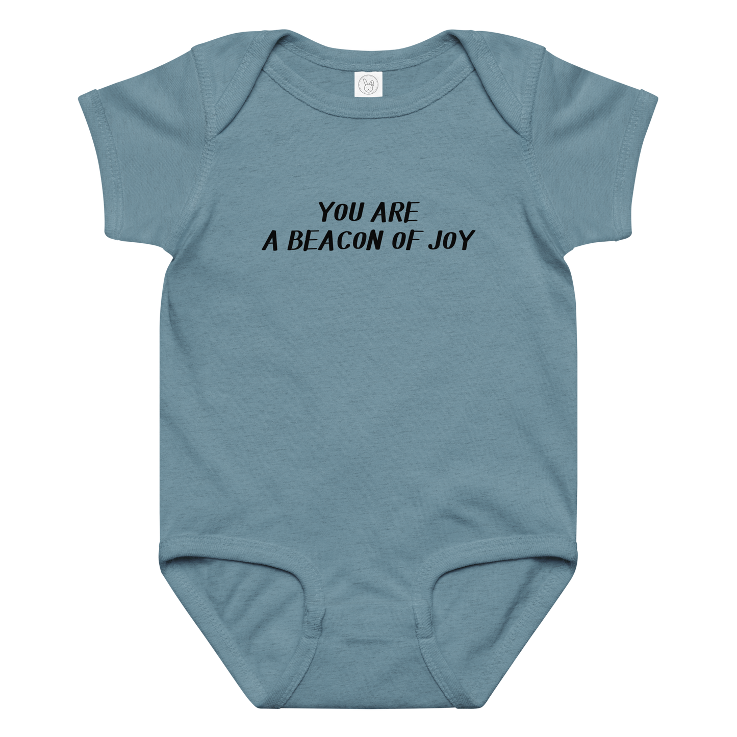 "You are a beacon of joy" printed on a vintage indigo baby jersey bodysuit laying on a flat surface amongst other clothes
