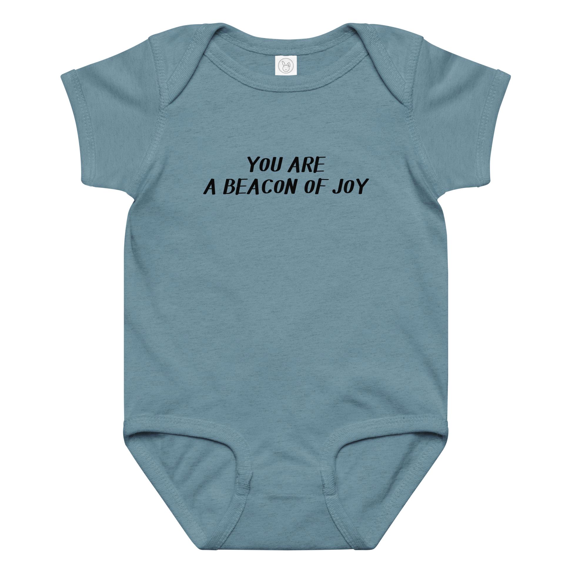 "You are a beacon of joy" printed on a vintage indigo baby jersey bodysuit laying on a flat surface amongst other clothes