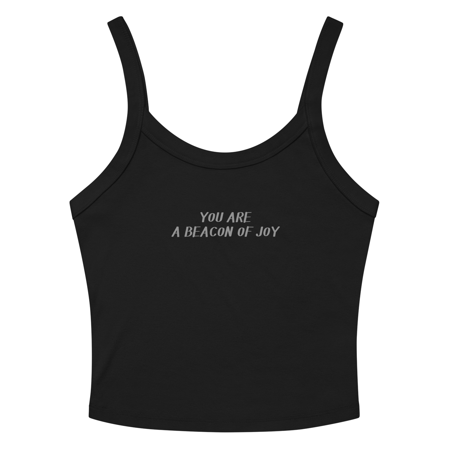 "You are a beacon of joy" printed on a solid black blend women's micro-rib tanktop laying on a flat surface amongst sunglasses and shorts