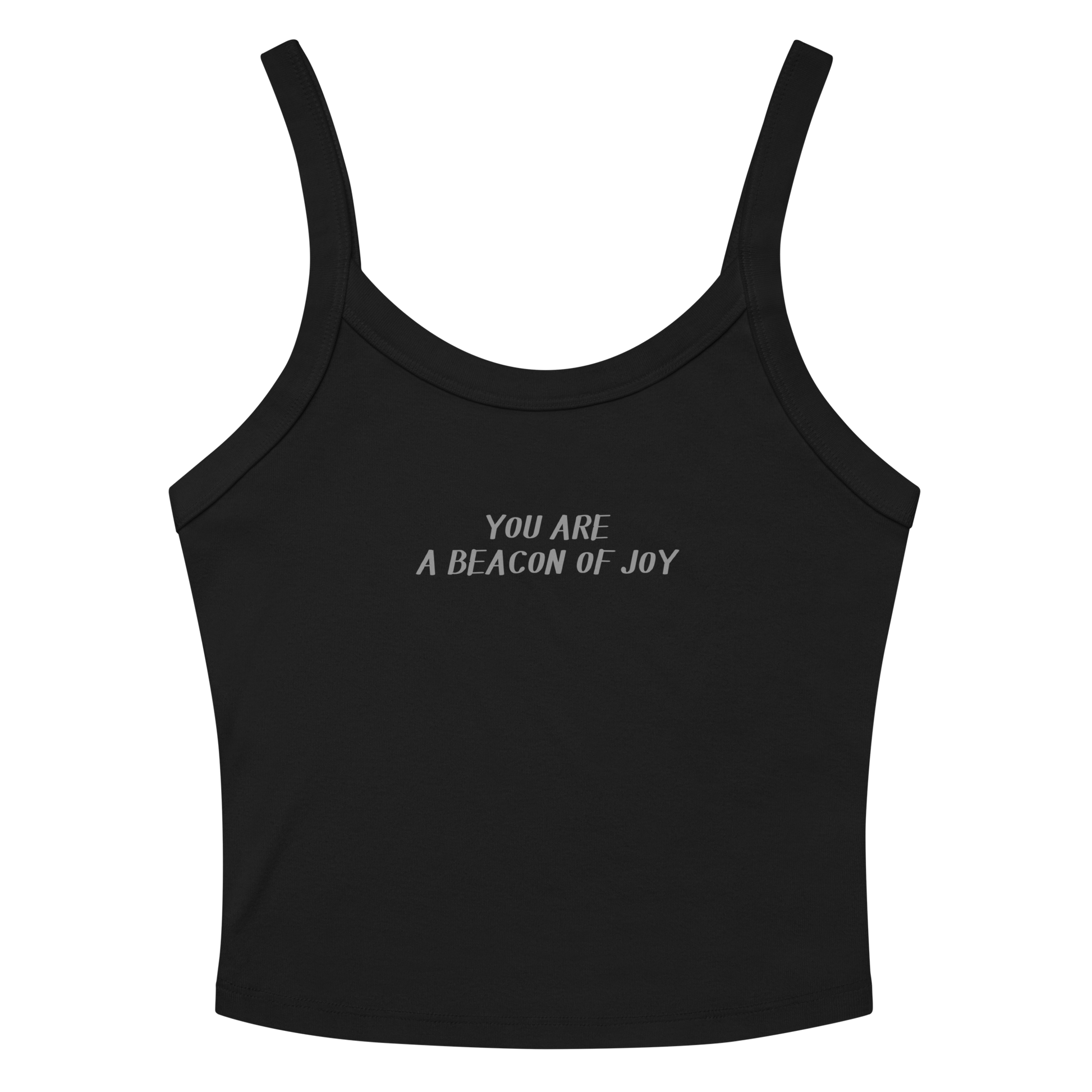 "You are a beacon of joy" printed on a solid black blend women's micro-rib tanktop laying on a flat surface amongst sunglasses and shorts