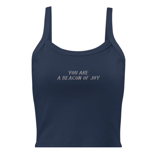 "You are a beacon of joy" printed on a solid navy blend women's micro-rib tanktop laying on a flat surface
