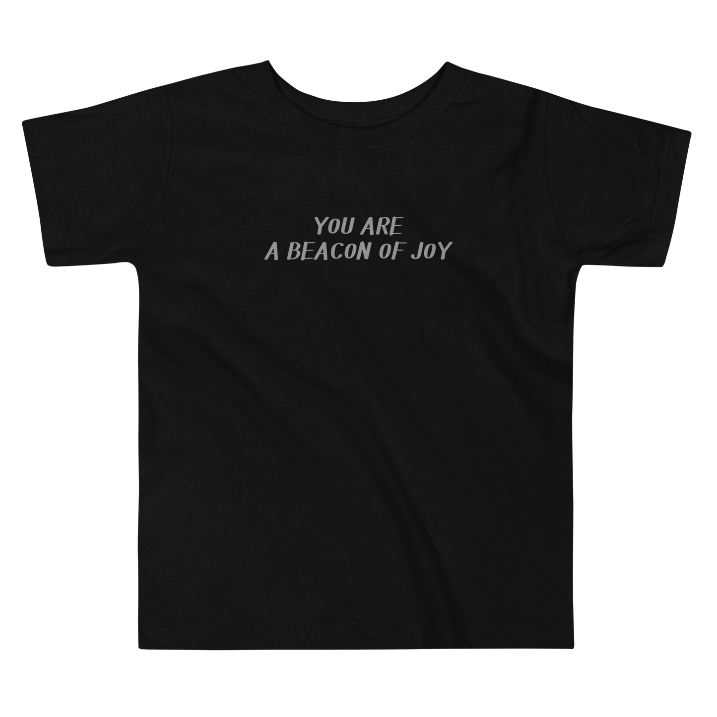 "You are a beacon of joy" printed on a black toddler short sleeve tee laying on a flat surface