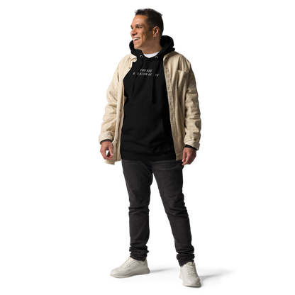 "You are a beacon of joy" printed on a black unisex hoodie worn by a male with a jacket on top