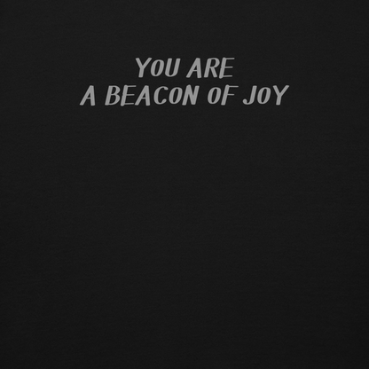 "You are a beacon of joy" printed on a black background
