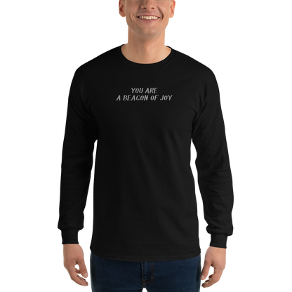 "You are a beacon of joy" printed on a black men's long sleeve shirt worn by a male