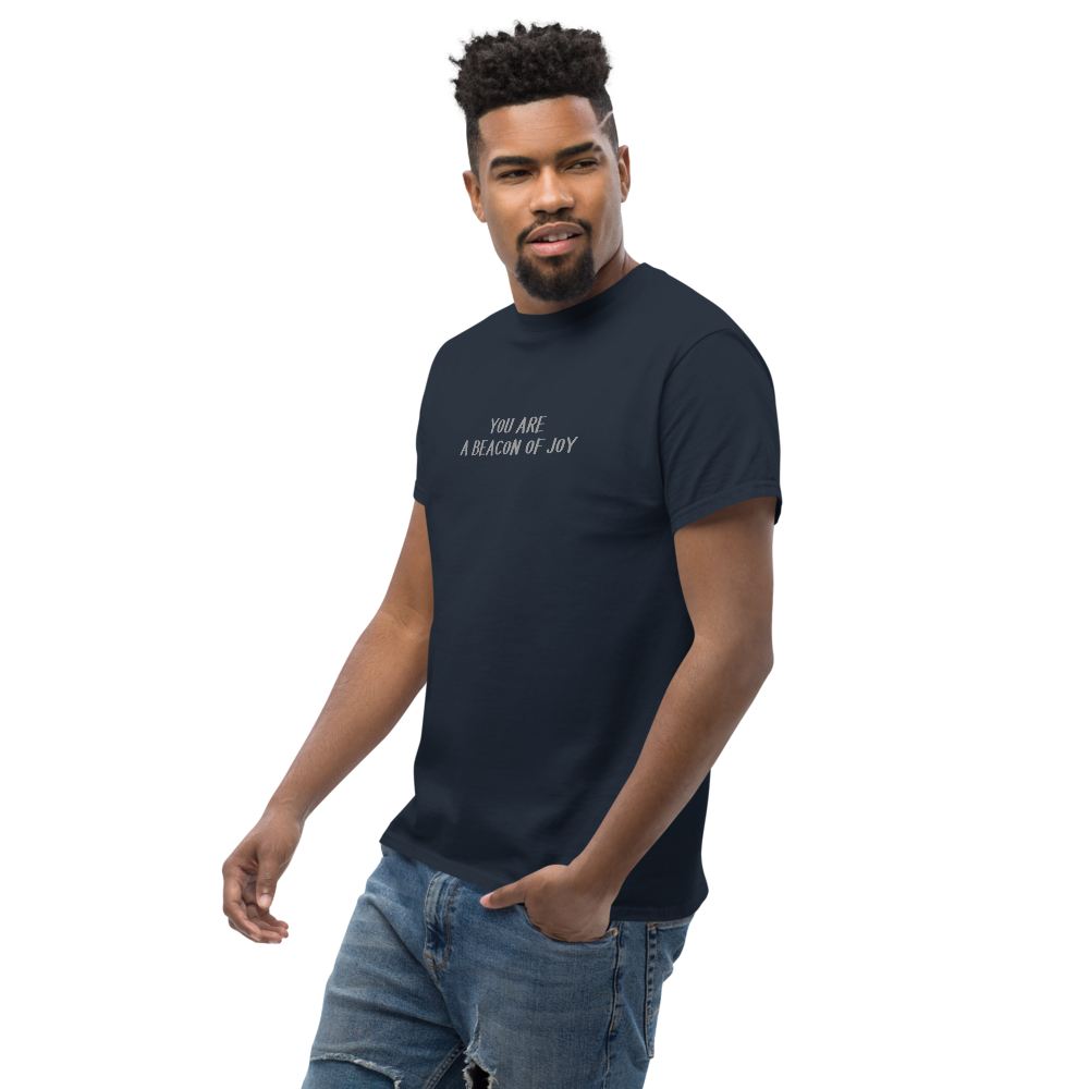 "You are a beacon of joy" printed on a navy unisex classic tee worn by a male
