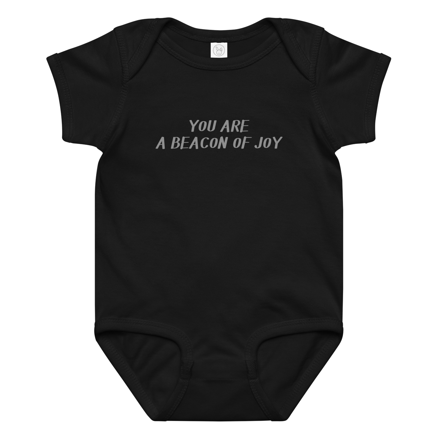 "You are a beacon of joy" printed on a black baby jersey bodysuit laying on a flat surface amongst other clothes