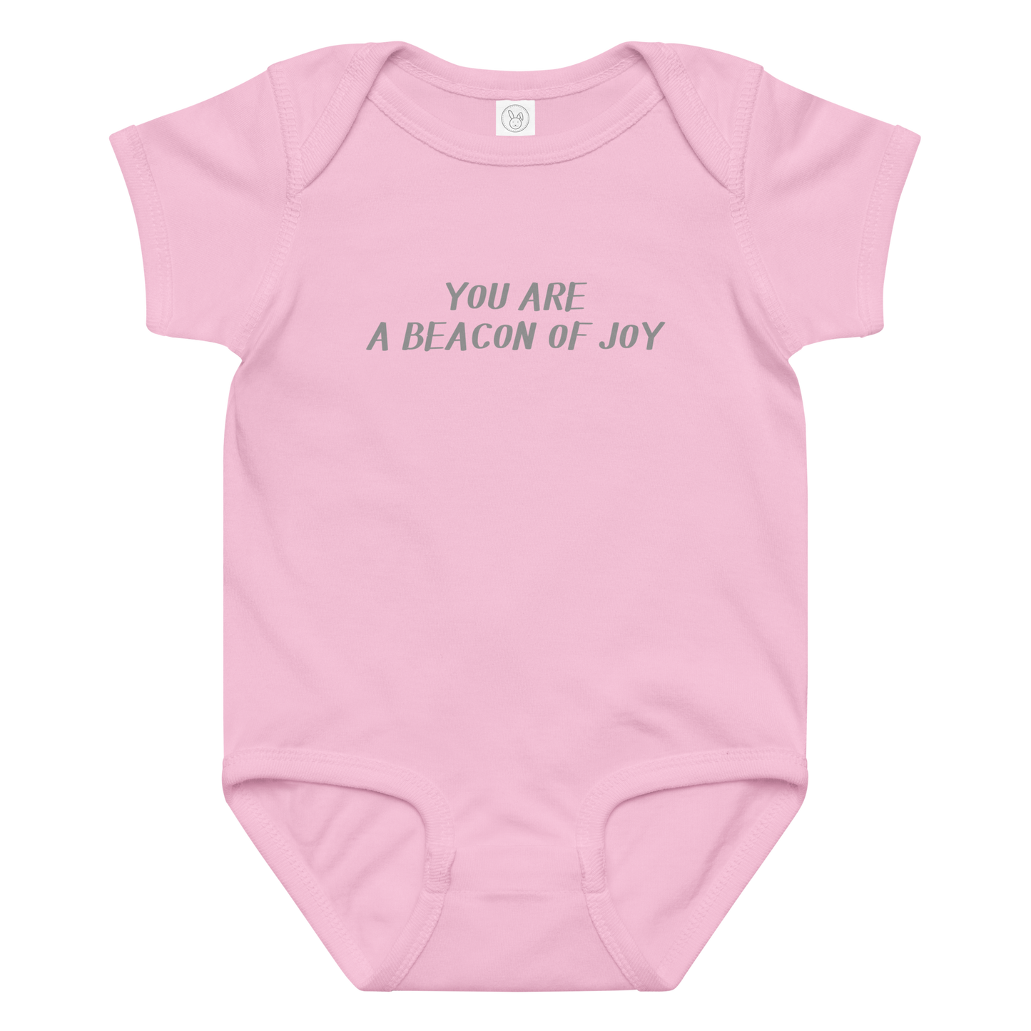 "You are a beacon of joy" printed on a pink baby jersey bodysuit laying on a flat surface amongst other clothes