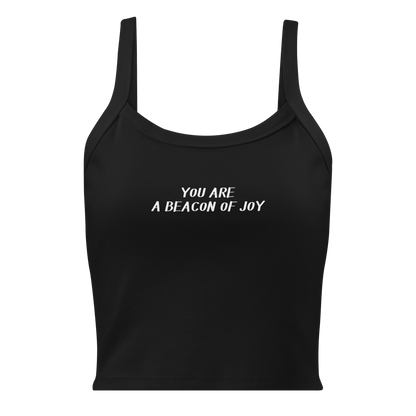"You are a beacon of joy" printed on a solid black blend women's micro-rib tanktop laying on a flat surface