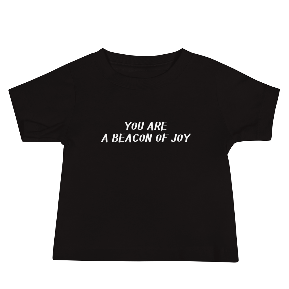 "You are a beacon of joy" printed on a black baby jersey short sleeve tee laying on a flat surface