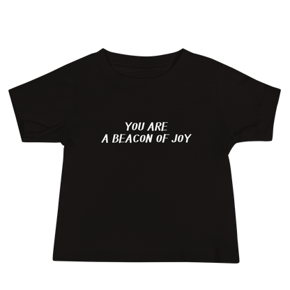 "You are a beacon of joy" printed on a black baby jersey short sleeve tee laying on a flat surface