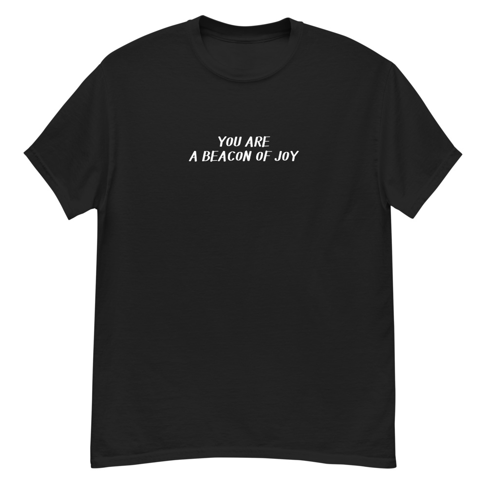 "You are a beacon of joy" printed on a black unisex classic tee laying on a flat surface
