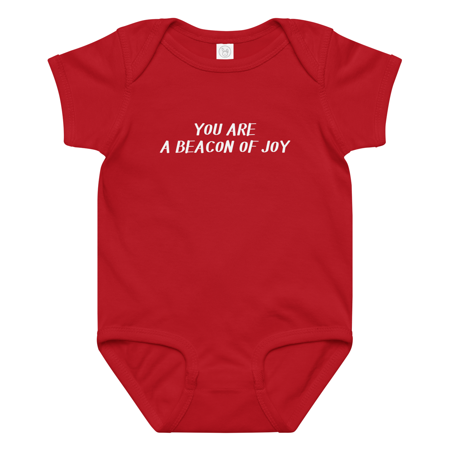 "You are a beacon of joy" printed on a red baby jersey bodysuit laying on a flat surface amongst other clothes