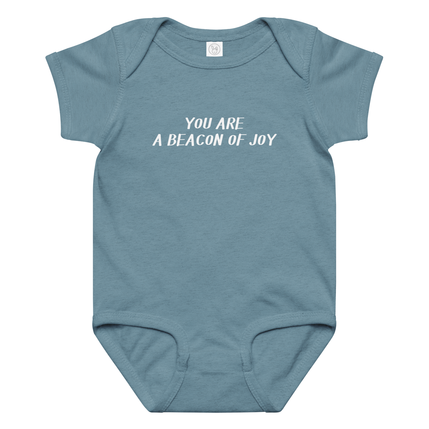 "You are a beacon of joy" printed on a vintage indigo baby jersey bodysuit laying on a flat surface amongst other clothes