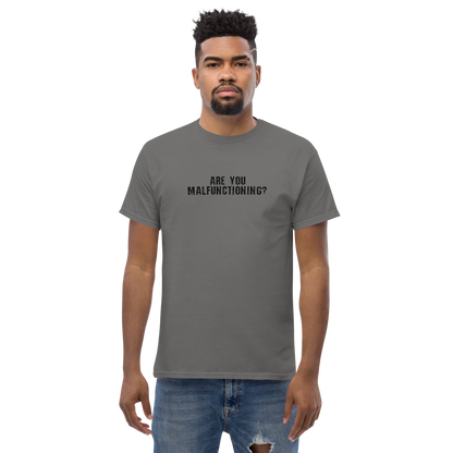 "Are you malfunctioning?" printed on a charcoal unisex classic tee worn by a male