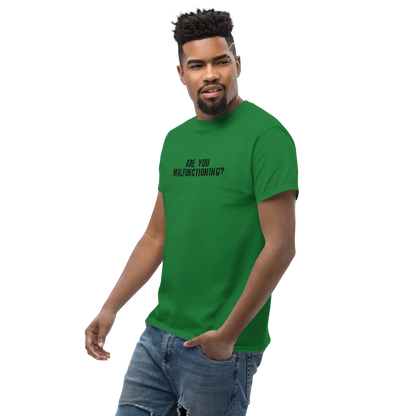 "Are you malfunctioning?" printed on a turf green unisex classic tee worn by a male