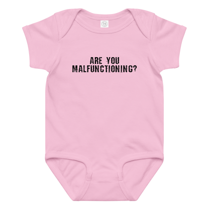 "Are you malfunctioning?" printed on a pink baby jersey bodysuit laying on a flat surface amongst other clothes