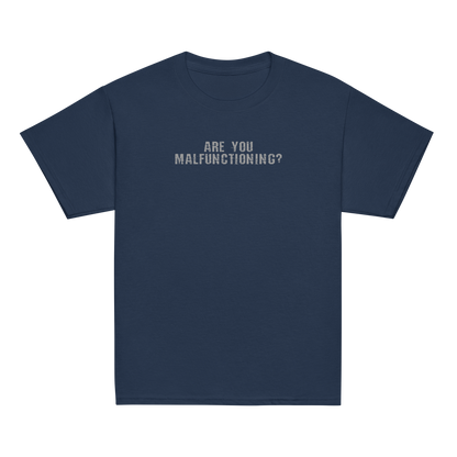 "Are you malfunctioning?" printed on a navy youth classic tee laying on a flat surface