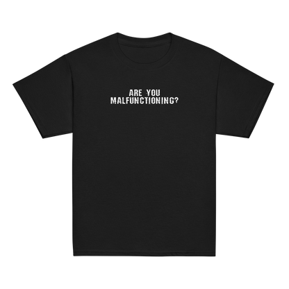 "Are you malfunctioning?" printed on a black youth classic tee laying on a flat surface