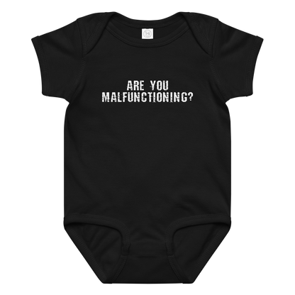 "Are you malfunctioning?" printed on a black baby jersey bodysuit laying on a flat surface amongst other clothes