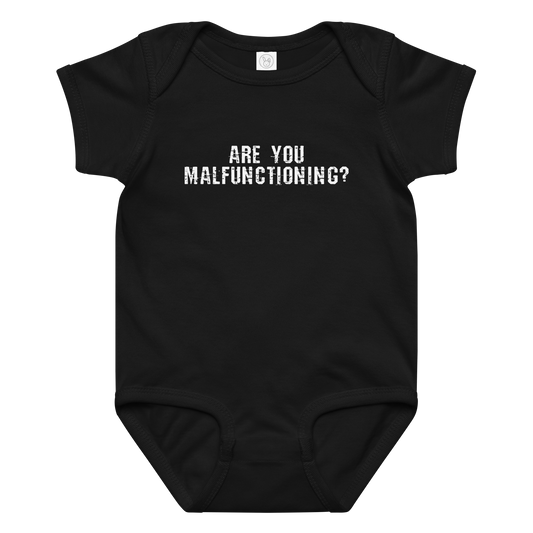 "Are you malfunctioning?" printed on a black baby jersey bodysuit laying on a flat surface amongst other clothes